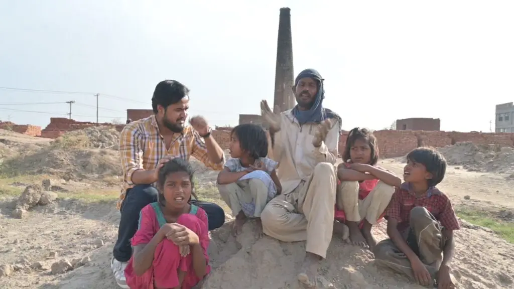 Mehboob Masih and his children sitting together, celebrating their freedom from brick kiln slavery