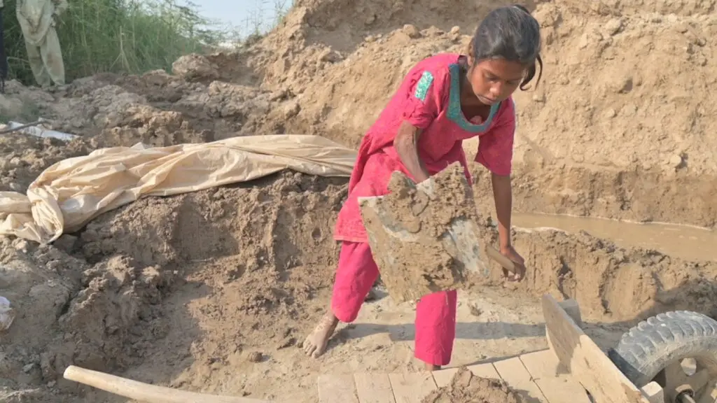 A child working in the harsh conditions of the brick kilns before being rescued
