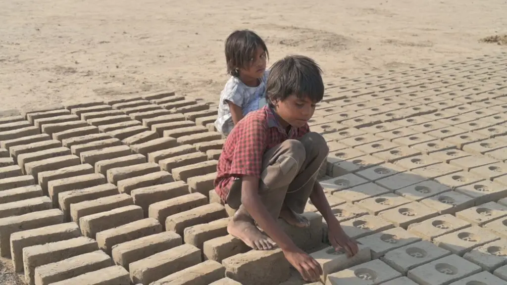 Children working in the harsh conditions of the brick kilns before being rescued
