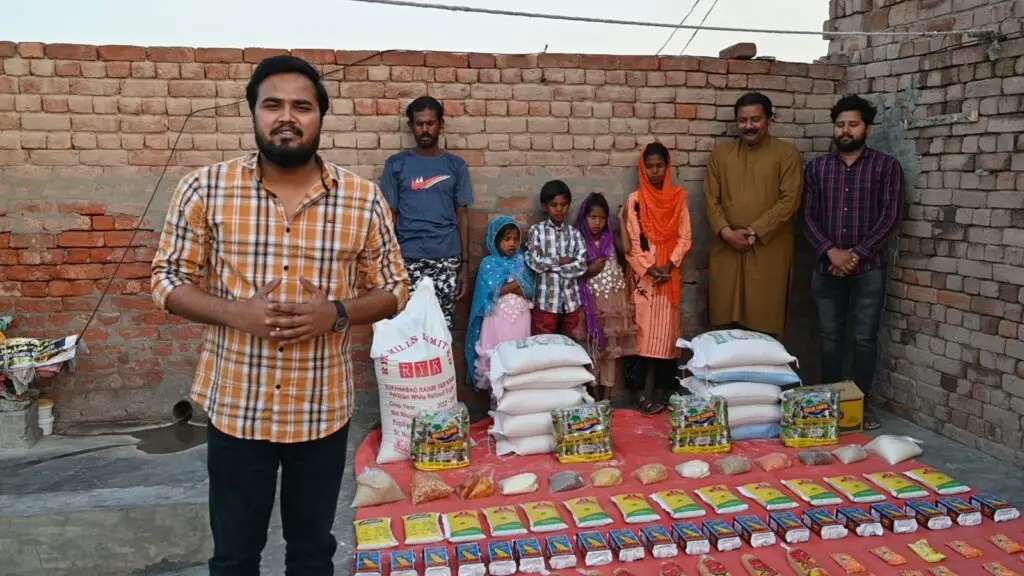 Ground team and Mehboob Masih's family standing with new supplies after their rescue from brick kiln slavery