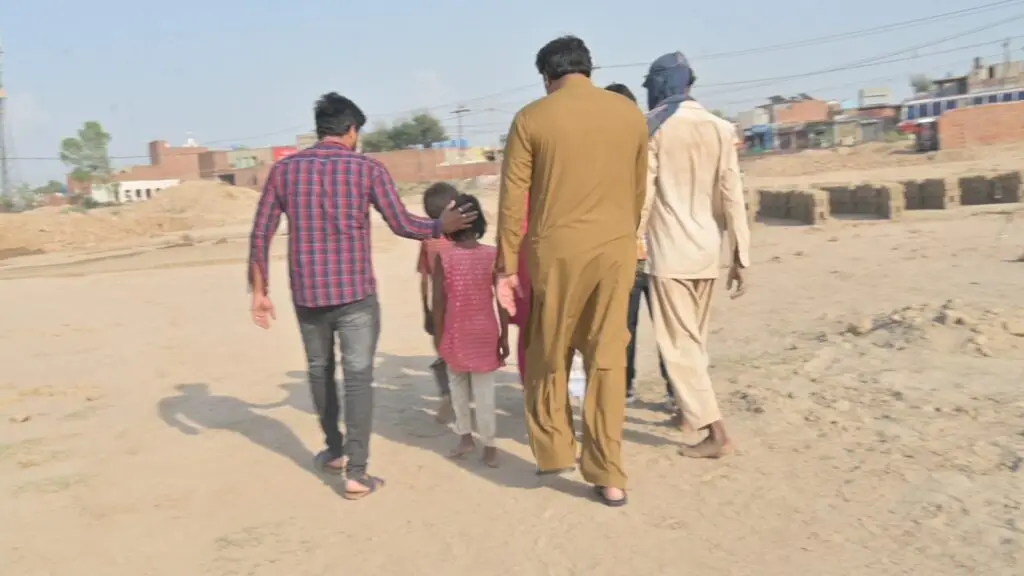 Mehboob Masih and his family walking away from the brick kilns after being rescued from bonded labor